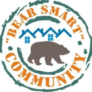 The Bear Smart Community Program logo, showing a bear walking in front of houses.